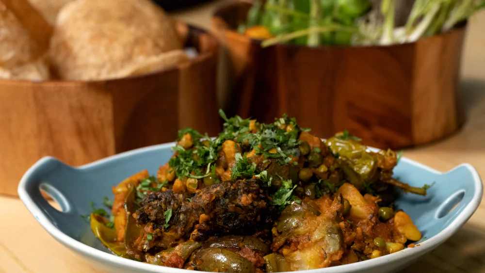 gujarati traditional thali items undhiyu dal kadhi